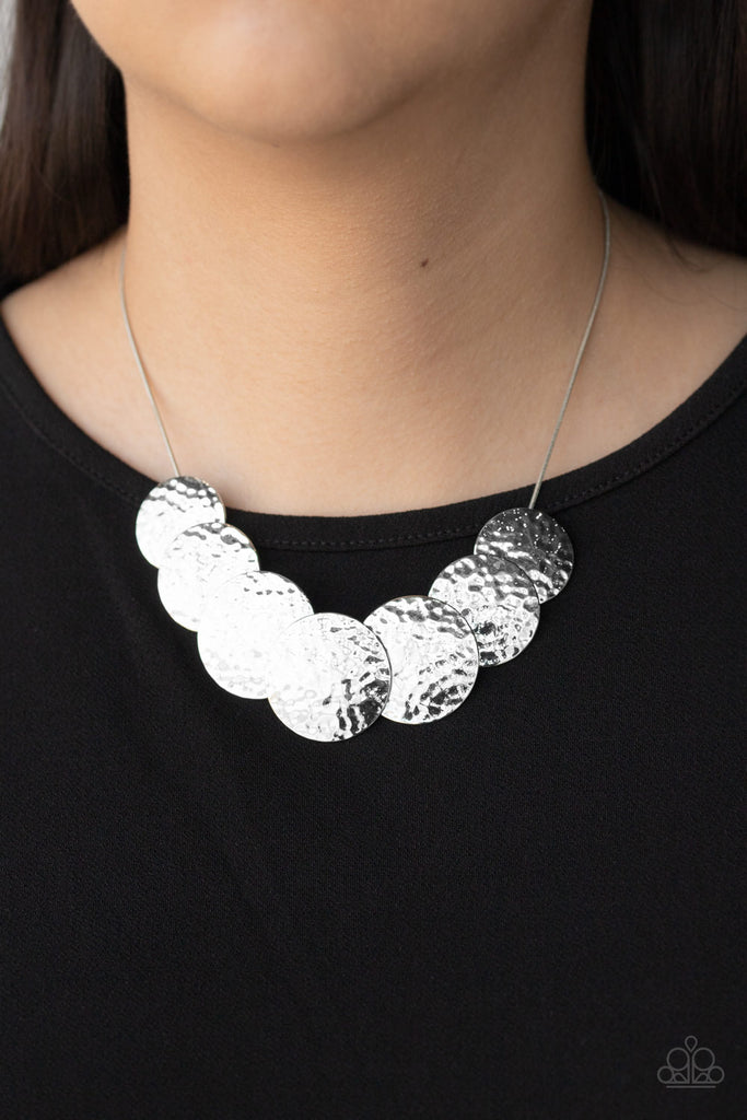 Hammered silver discs slide along a rounded snake chain, overlapping into a blinding statement piece below the collar. Features an adjustable clasp closure.  Sold as one individual necklace. Includes one pair of matching earrings.
