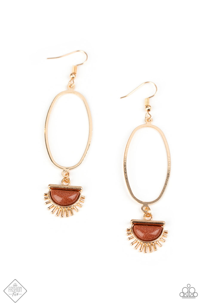 sol-purpose-gold  A golden sunburst charm with a goldstone center dangles from the bottom of an elongated oval hoop for a trendy vibe. Earring attaches to a standard fishhook fitting.  Sold as one pair of earrings.