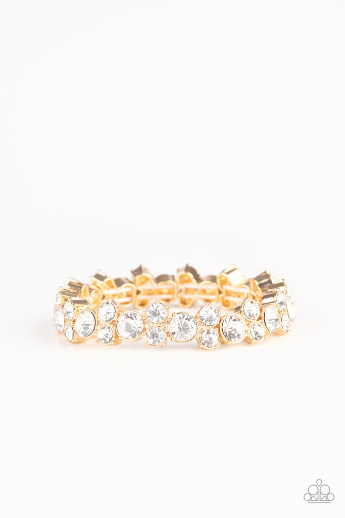 here-comes-the-bribe-gold Featuring sleek gold frames, trios of glittery white rhinestones are threaded along stretchy bands around the wrist for a timeless shimmer.  Sold as one individual bracelet.