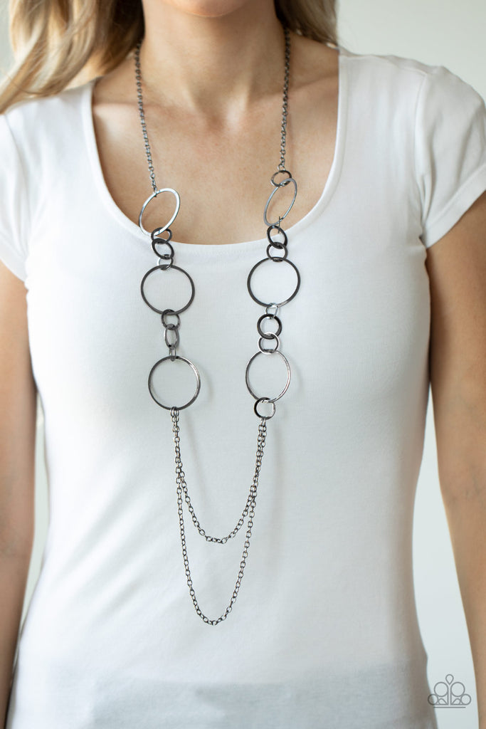 A mismatched collection of flat gunmetal rings give way to two rows of shimmery gunmetal chains, creating casual tone on tone layers down the chest. Features an adjustable clasp closure.  Sold as one individual necklace. Includes one pair of matching earrings.