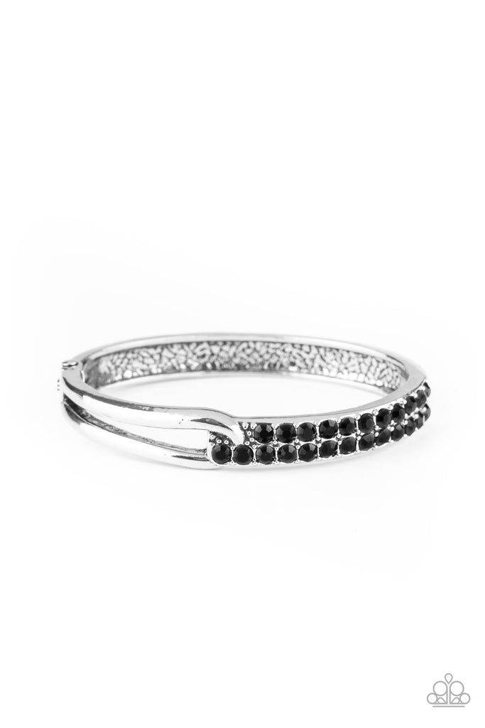 An airy silver fitting links with a silver band encrusted in two rows of glittery black rhinestones across the wrist, creating an edgy bangle-like cuff. Features a hinged closure.  Sold as one individual bracelet.  