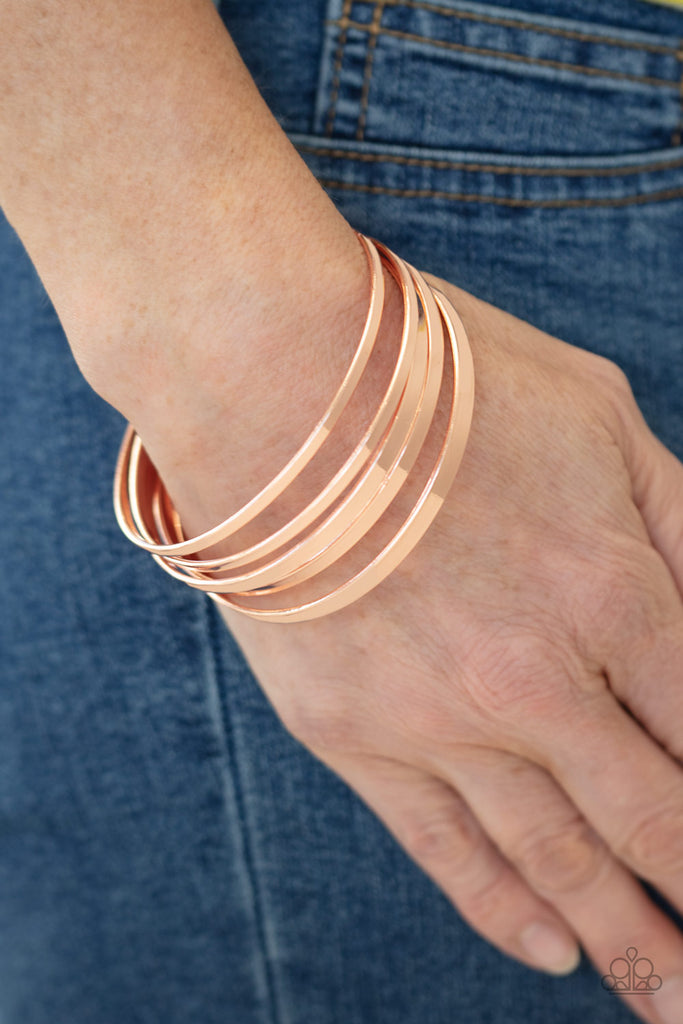 A collection of flat shiny copper bangles stack along the wrist, creating an irresistible edgy shimmer.  Sold as one set of five bracelets.