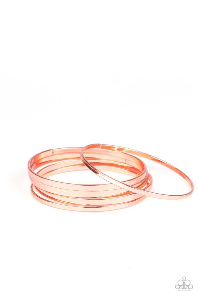 A collection of flat shiny copper bangles stack along the wrist, creating an irresistible edgy shimmer.  Sold as one set of five bracelets.