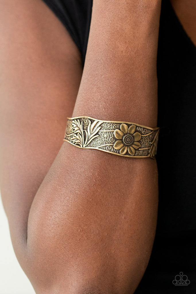 The front of an asymmetrical brass cuff is stamped and embossed in lacy vines and a leafy floral pattern for a whimsical fashion.  Sold as one individual bracelet.