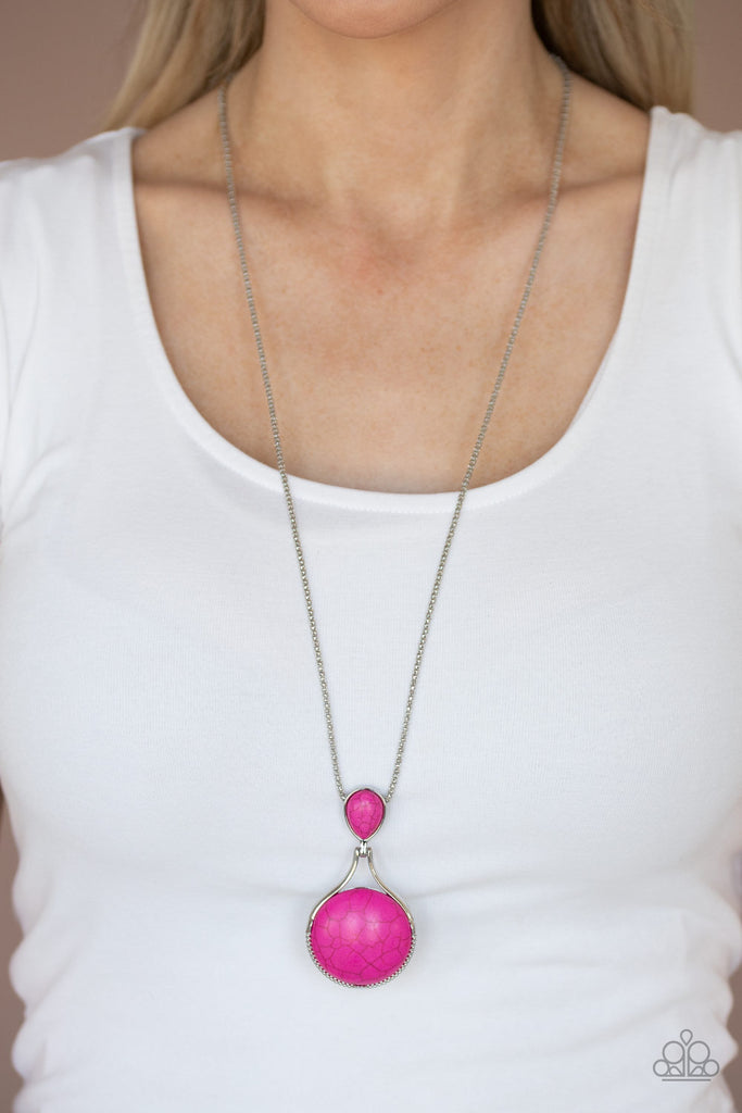 Encased in silver, a teardrop pink stone hinges to a large round pink stone at the bottom of a lengthened silver popcorn chain, creating a one-of-a-kind pendant. Features an adjustable clasp closure.  Sold as one individual necklace. Includes one pair of matching earrings.