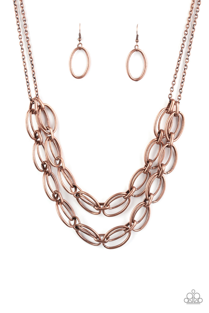 status-quo-copper Varying in size, pairs of oval copper links connect into two bold layers below the collar for a gritty industrial look. Features an adjustable clasp closure.  Sold as one individual necklace. Includes one pair of matching earrings.