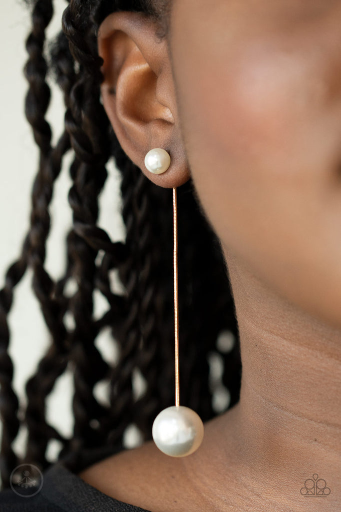 Attached to a sleek gold chain, an oversized white pearl delicately swings from the bottom of a classic white pearl, adding a timeless twist to the elegant display. Earring attaches to a standard post fitting.  Sold as one pair of post earrings.