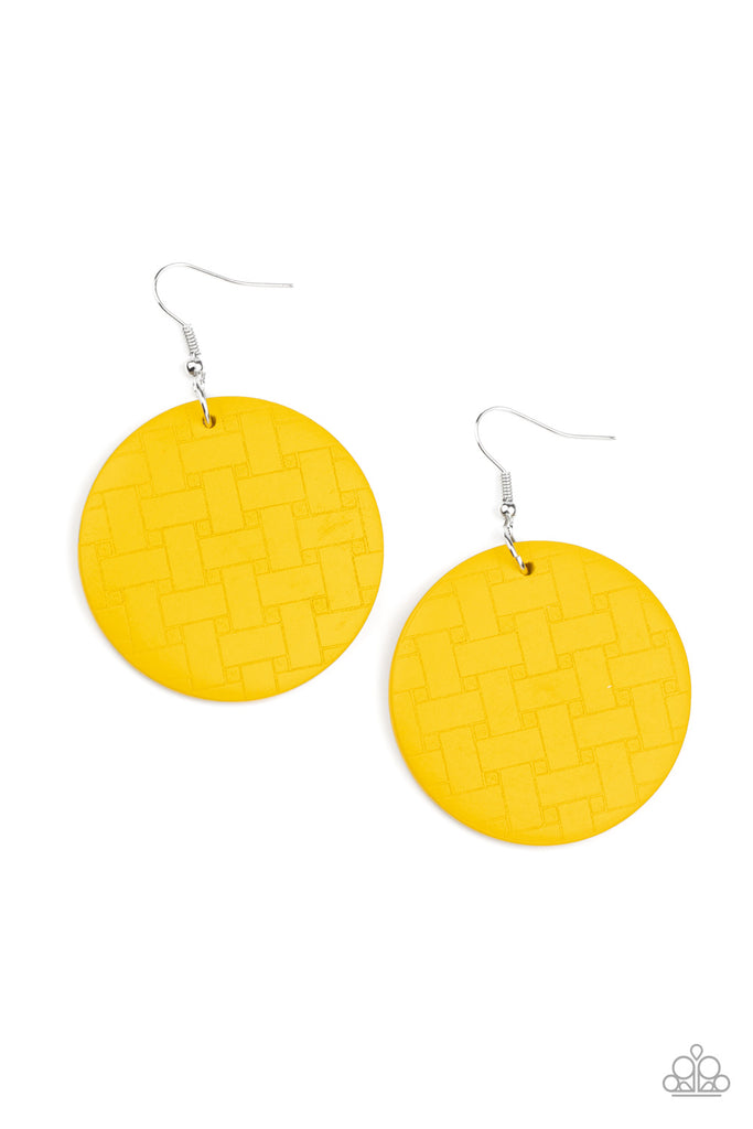 Engraved in a woven geometric pattern, an earthy yellow wooden disc swings from the ear for a natural-inspired look. Earring attaches to a standard fishhook fitting.  Sold as one pair of earrings.