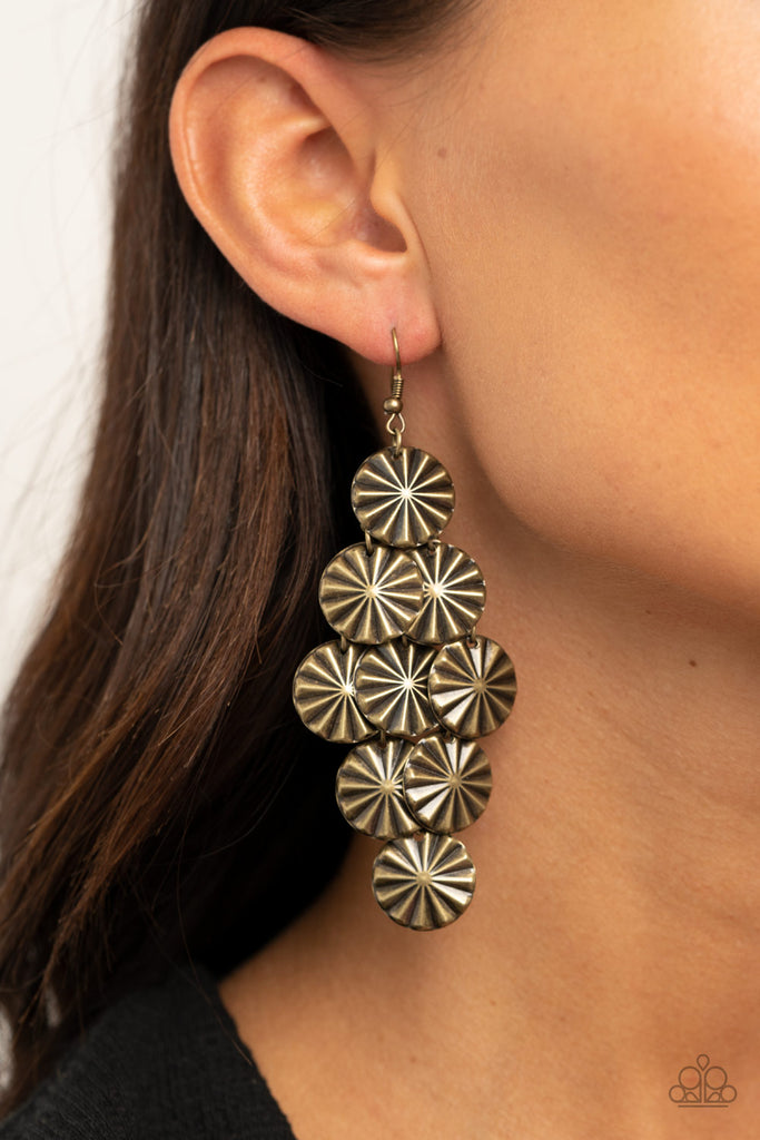 Creased in star-like patterns, antiqued brass discs attach to a brass netted backdrop, linking into an edgy lure. Earring attaches to a standard fishhook fitting.  Sold as one pair of earrings.