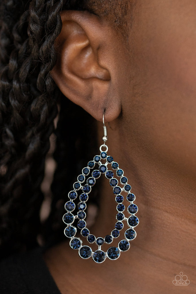 Varying in size, rows of glittery blue rhinestones coalesce into two blinding teardrops for a jaw-dropping dazzle. Earring attaches to a standard fishhook fitting.  Sold as one pair of earrings.