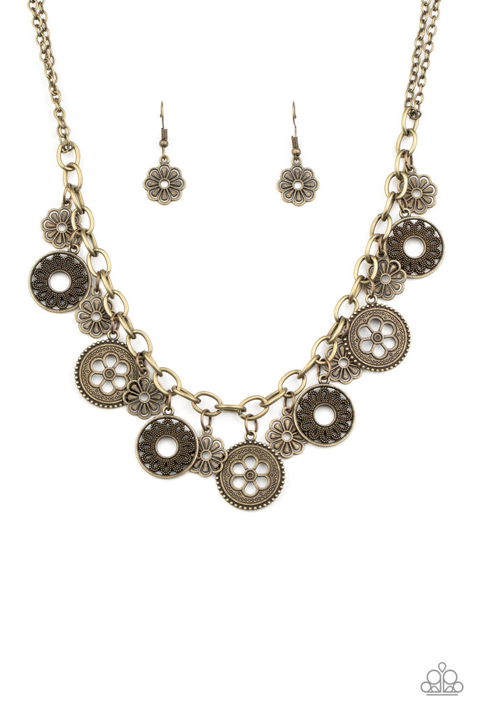 A collection of antiqued floral charms dangles from a thick brass chain, creating a whimsical fringe below the collar. Features an adjustable clasp closure.  Sold as one individual necklace. Includes one pair of matching earrings.