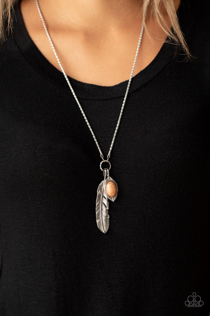 Dotted with a brown stone, a dainty silver leaf charm joins a lifelike silver feather charm at the bottom of a lengthened silver popcorn chain, creating a whimsical pendant. Features an adjustable clasp closure.  Sold as one individual necklace. Includes one pair of matching earrings.