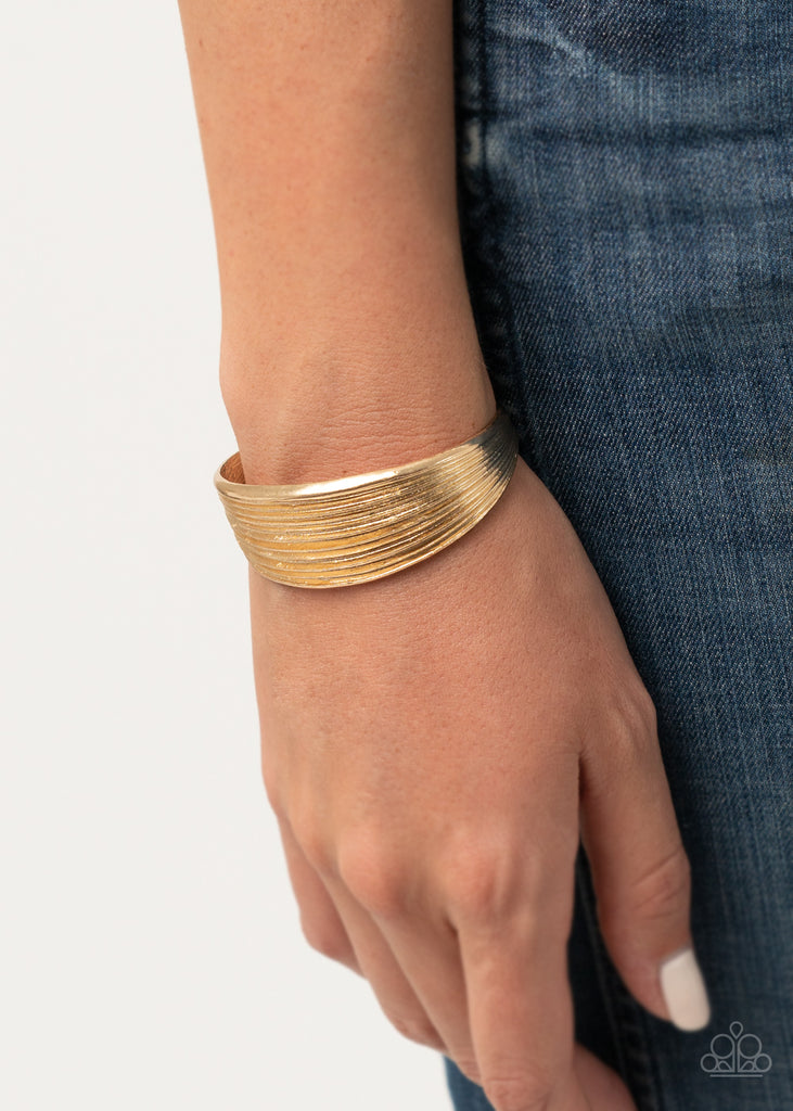 Featuring beveled linear texture, a sleek gold cuff delicately curls around the wrist for a dash of casual refinement.  Sold as one individual bracelet.  🟢 runs a little small.  May fit best on wrists with circumference of about 6.5 inches or less.