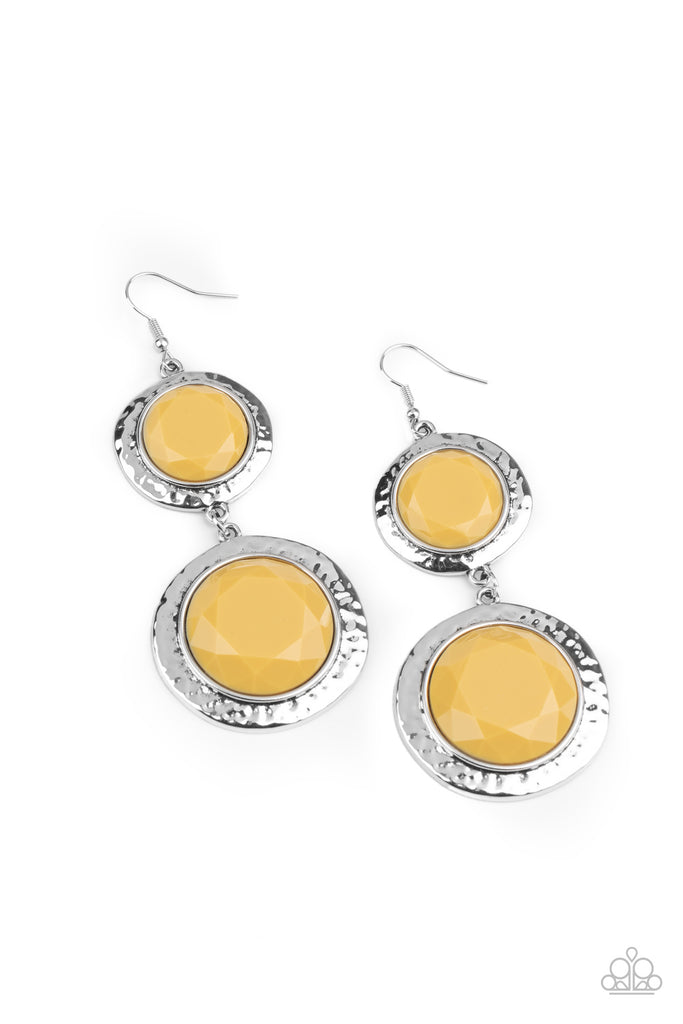 thrift-shop-stop-yellow Varying in size, a pair of faceted yellow beads are pressed into the shimmery centers of hammered silver frames as they link into a colorfully rustic lure. Earring attaches to a standard fishhook fitting.  Sold as one pair of earrings.