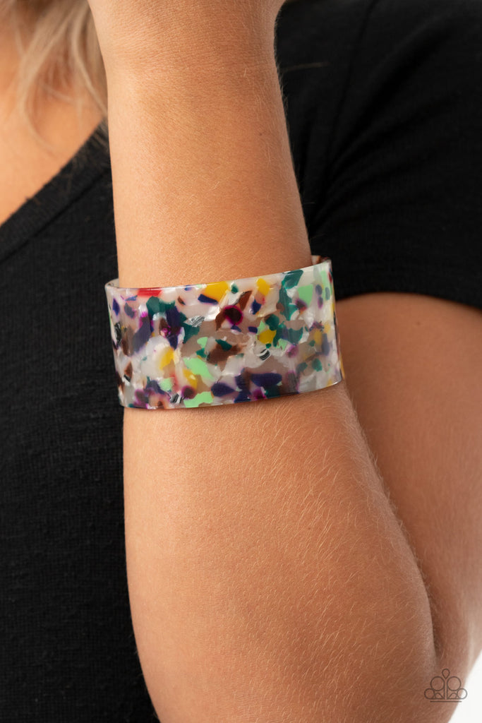 Featuring a multicolored tortoise shell-like pattern, a thick acrylic cuff delicately curls around the wrist for a colorfully chic look.  Sold as one individual bracelet.