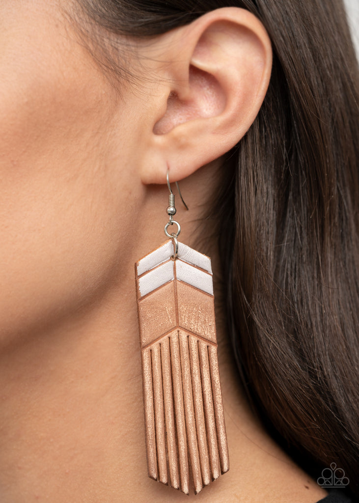 Painted in white chevron-like details, a distressed leather frame is spliced into tasseled ends, creating an earthy fringe. Earring attaches to a standard fishhook fitting.  Sold as one pair of earrings.