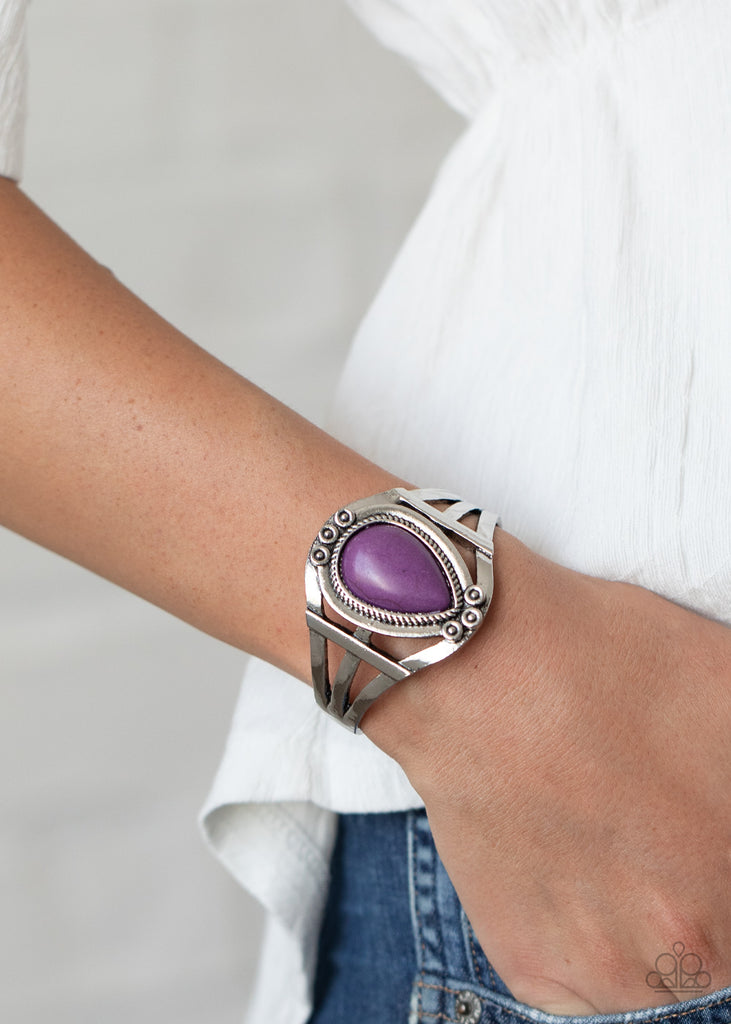 A teardrop purple stone is pressed into the center of a layered silver cuff dotted and decorated into studded and rope-like textures for a southwest inspired look.  Sold as one individual bracelet.