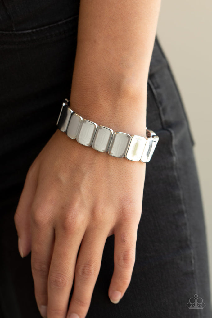 Brushed in an antiqued shimmer, burnished silver rectangular frames are threaded along stretchy bands around the wrist for a rustic look.  Sold as one individual bracelet.  