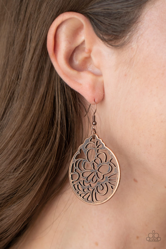 Brushed in an antiqued shimmer, a round copper frame is stenciled in an airy floral cut-out pattern for a whimsical look. Earring attaches to a standard fishhook fitting.  Sold as one pair of earrings.