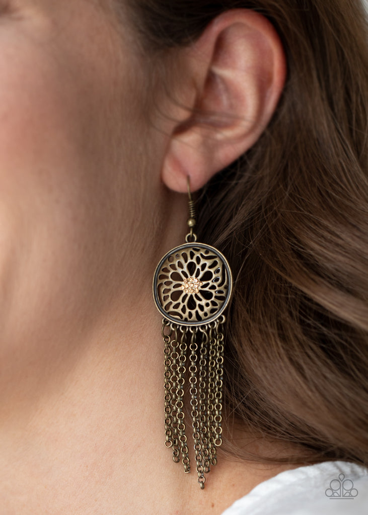 Dotted with dainty topaz rhinestones, an antiqued brass floral frame gives way to a fringe of dainty brass chains, creating a whimsically tasseled look. Earring attaches to a standard fishhook fitting.  Sold as one pair of earrings.