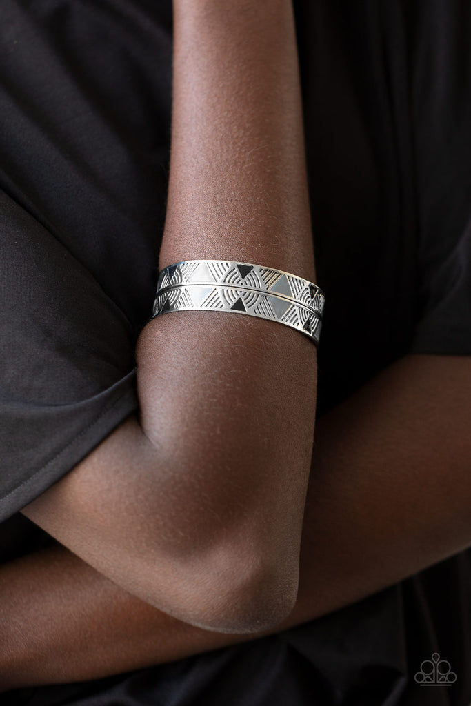 Painted in shiny black and gray triangular accents, a thick silver cuff embossed in a dizzying linear pattern has been spliced down the center for a tactile finish.  Sold as one individual bracelet.  