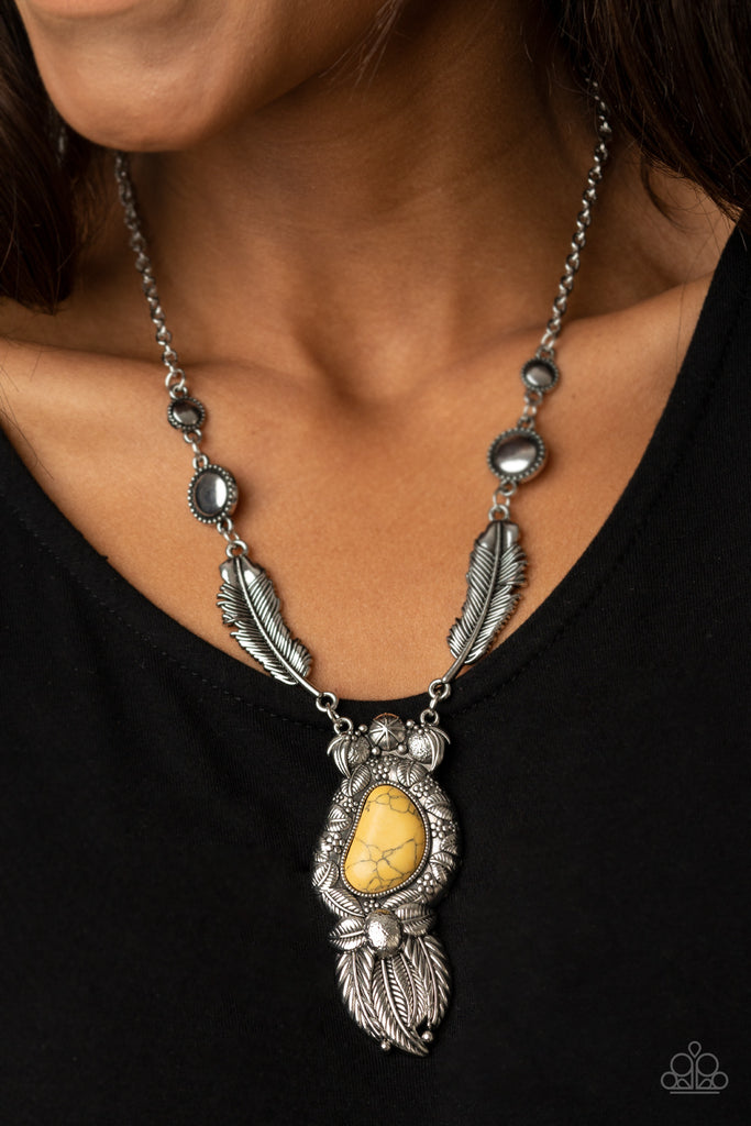 Featuring sunburst patterns, a dainty collection of silver beads connect to two silver feather frames that give way to a one-of-a-kind yellow stone pendant. Embossed in floral and leafy patterns, the sunny stone pendant gives way to a stationary fringe of overlapping silver feathers for a whimsical finish. Features an adjustable clasp closure.  Sold as one individual necklace. Includes one pair of matching earrings.