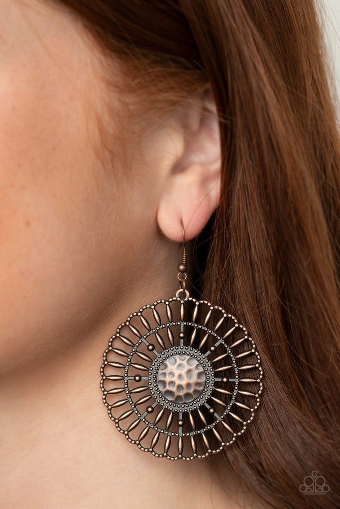 Rustic copper bars fan out from a studded and hammered copper center, coalescing into an airy scalloped frame. Earring attaches to a standard fishhook fitting.  Sold as one pair of earrings.