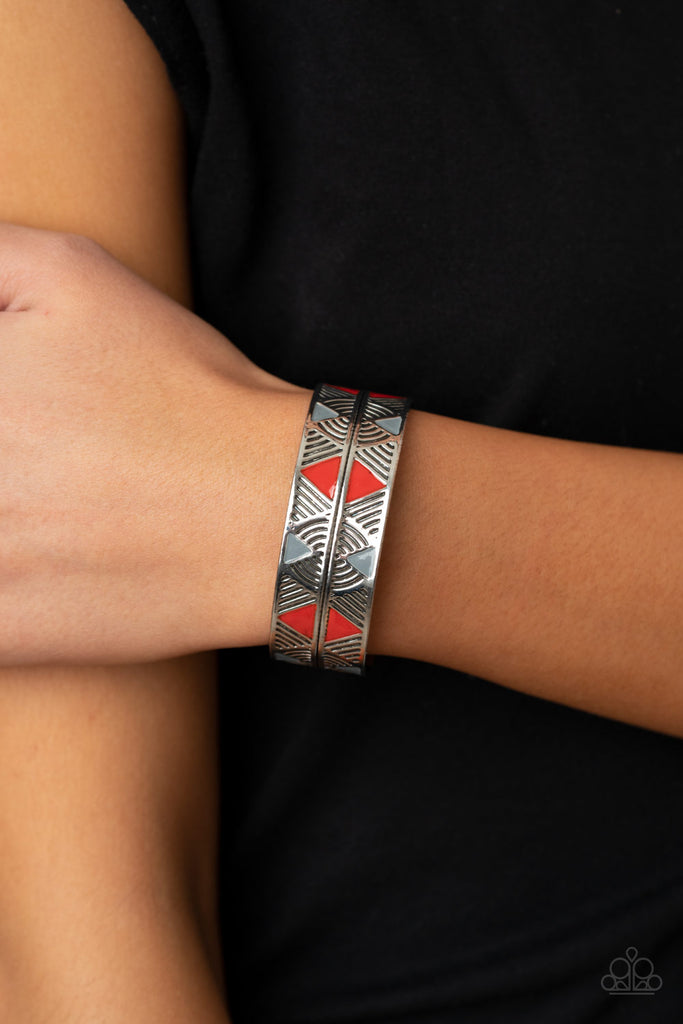 Painted in shiny red and gray triangular accents, a thick silver cuff embossed in a dizzying linear pattern has been spliced down the center for a tactile finish.  Sold as one individual bracelet.