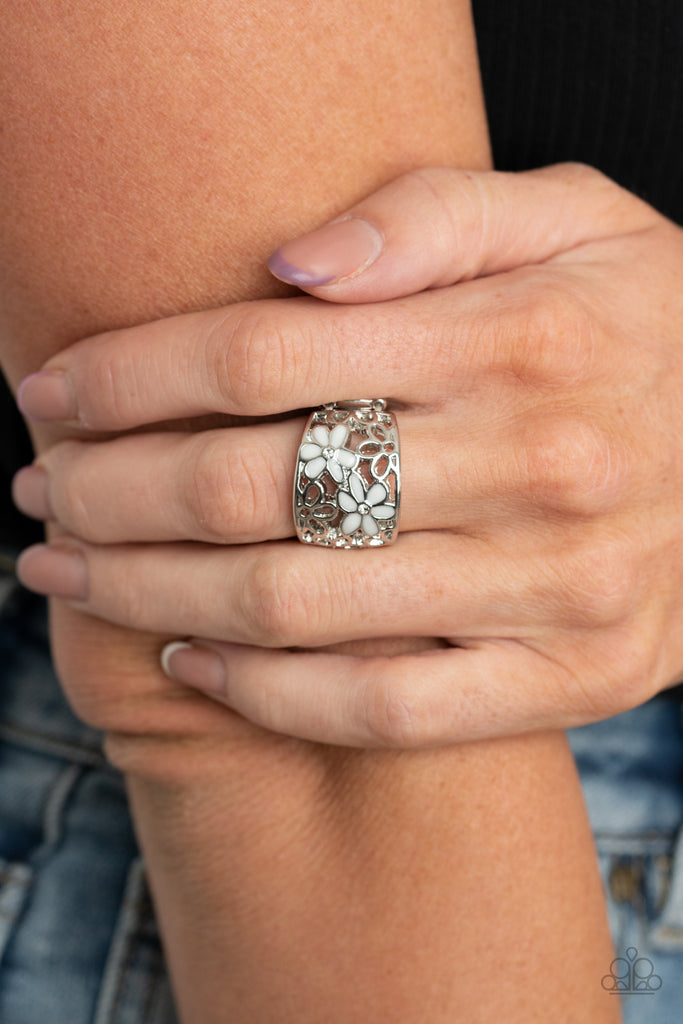 Dotted with dainty white rhinestone centers, two white flowers bloom across an airy stenciled backdrop of silver daisy filigree for a colorfully seasonal flair. Features a stretchy band for a flexible fit.  Sold as one individual ring.