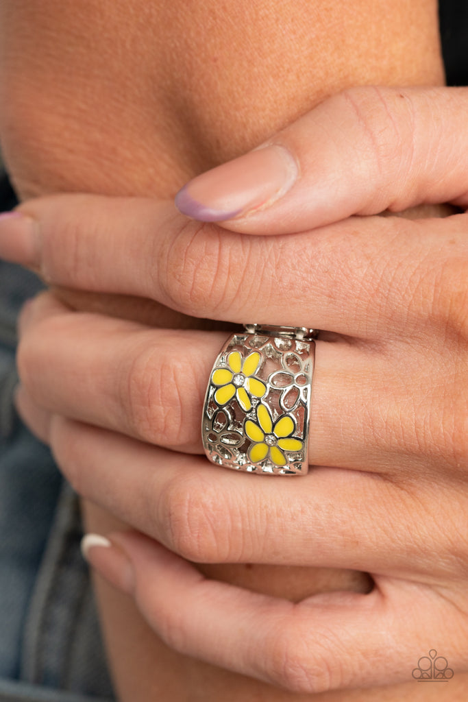 Dotted with dainty white rhinestone centers, two yellow flowers bloom across an airy stenciled backdrop of silver daisy filigree for a colorfully seasonal flair. Features a stretchy band for a flexible fit.  Sold as one individual ring.  