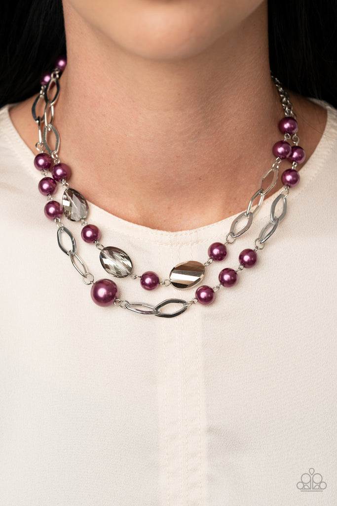 A mismatched collection of pearly purple beads, shimmery silver ovals, and metallic flecked crystal-like gems link into two polished rows below the collar, creating colorfully timeless layers. Feature an adjustable clasp closure.  Sold as one individual necklace. Includes one pair of matching earrings.