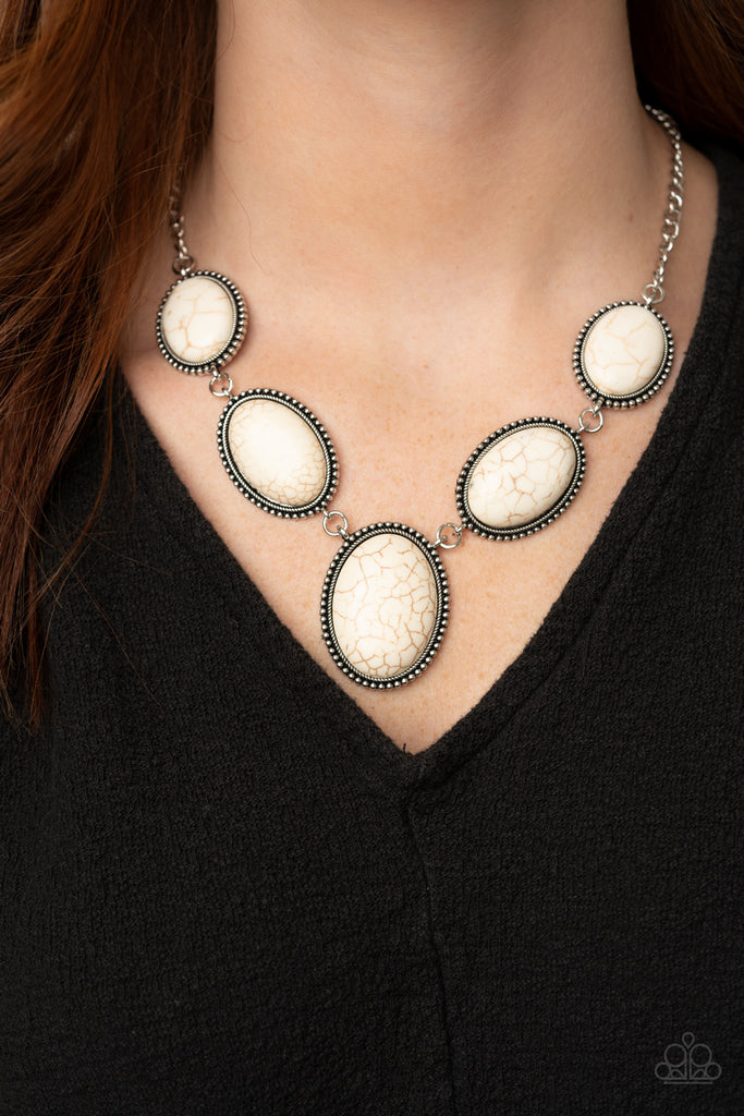 Bordered in rustic silver studded frames, a refreshing collection of oversized white stones delicately link below the collar for a seasonal stone look. Features an adjustable clasp closure.  Sold as one individual necklace. Includes one pair of matching earrings.  New Kit