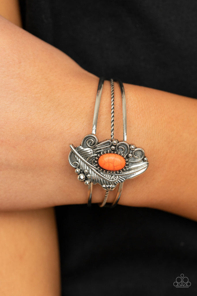 Dotted with a refreshing orange stone accent, a decorative silver feather frame is pressed into the center of an ornately layered cuff for a whimsical vibe.  Sold as one individual bracelet.