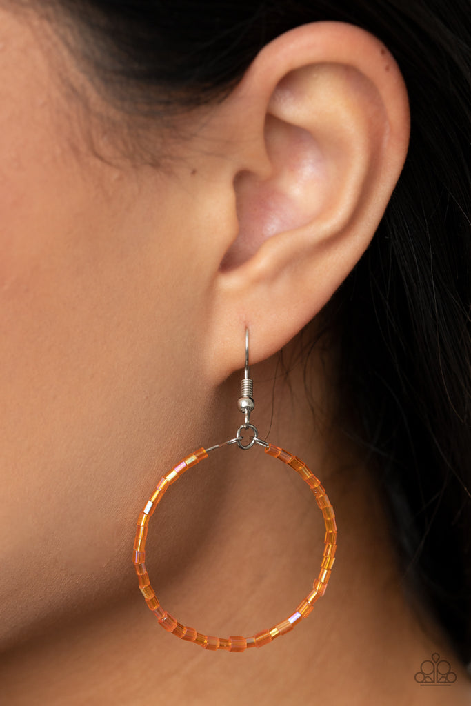 Featuring an iridescent shimmer, glassy orange seed beads are threaded along a dainty wire hoop for a colorful finish. Earring attaches to a standard fishhook fitting.  Sold as one pair of earrings.