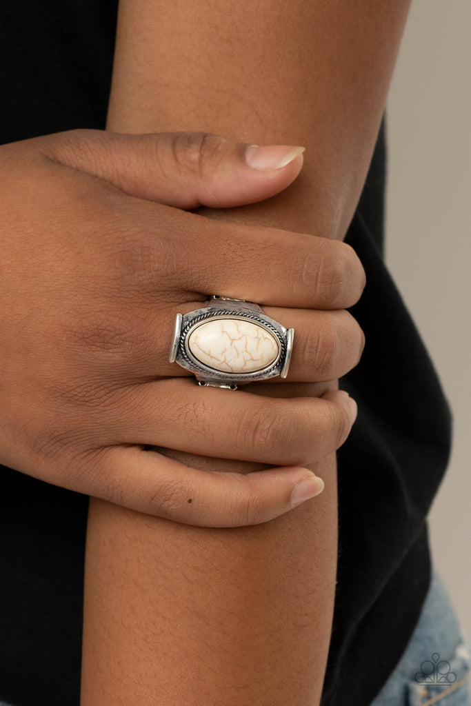 A refreshing white oval stone is nestled into a hammered silver plate that folds across the finger for a seasonal flair. Features a stretchy band for a flexible fit.  Sold as one individual ring.