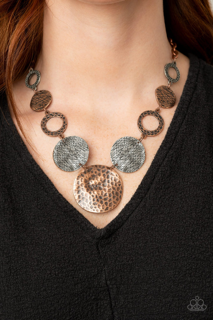 Featuring an array of scratched, hammered, and shiny antiqued finishes, a mismatched collection of imperfect copper and silver discs and hoops delicately connect below the collar to create a rustic statement piece. Features an adjustable clasp closure.  Sold as one individual necklace. Includes one pair of matching earrings.