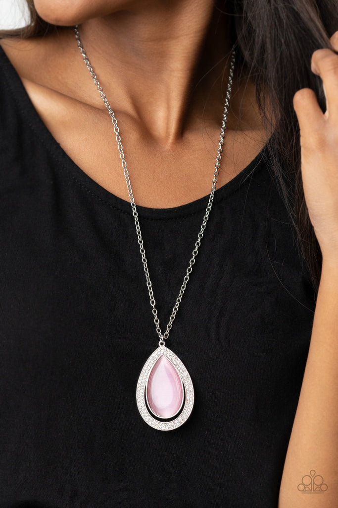 you-dropped-this-pink  An oversized pink cat's eye teardrop attaches to the top of a silver teardrop frame encrusted in glassy white rhinestones at the bottom of a lengthened silver chain, creating a glamorous pendant. Features an adjustable clasp closure.  Sold as one individual necklace. Includes one pair of matching earrings.
