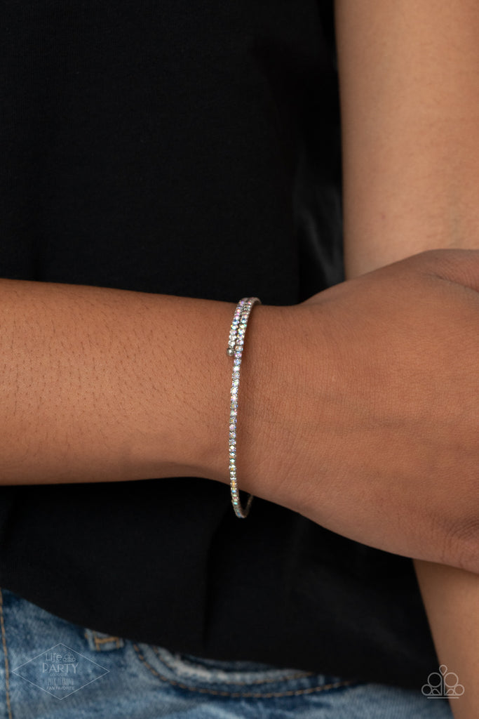 sleek-sparkle-multi Dotted in dainty iridescent rhinestones, a flexible wire coils around the wrist for a refined flair.  Sold as one individual bracelet.  This Fan Favorite is back in the spotlight at the request of our 2020 Life of the Party member with Pink Diamond Access, Monica V.