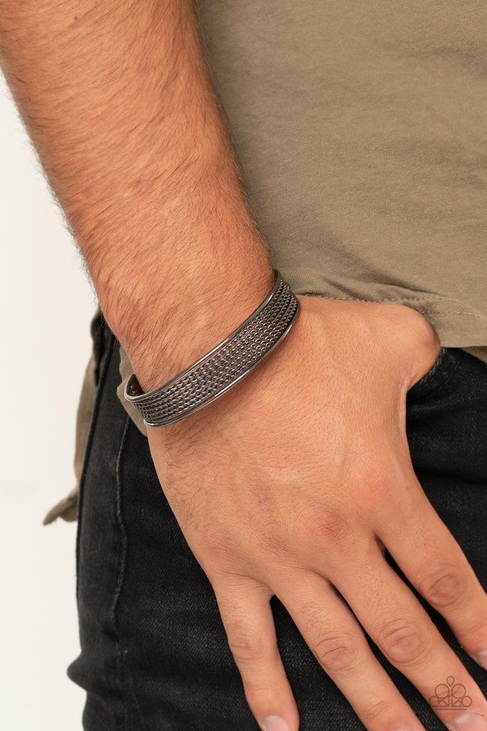 Sections of twisted gunmetal wires are bordered by two smooth gunmetal bars, coalescing into a bold industrial cuff around the wrist.  Sold as one individual bracelet.