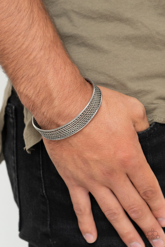 Sections of twisted silver wires are bordered by two smooth silver bars, coalescing into a bold industrial cuff around the wrist.  Sold as one individual bracelet.  