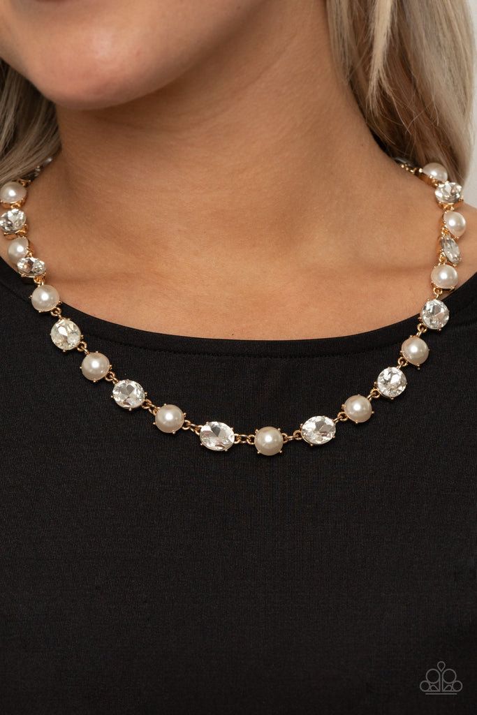 Encased in sleek gold fittings, a classic array of bubbly white pearls and glassy white rhinestones delicately link below the collar in a statement making finish. Features an adjustable clasp closure.  Sold as one individual necklace. Includes one pair of matching earrings.