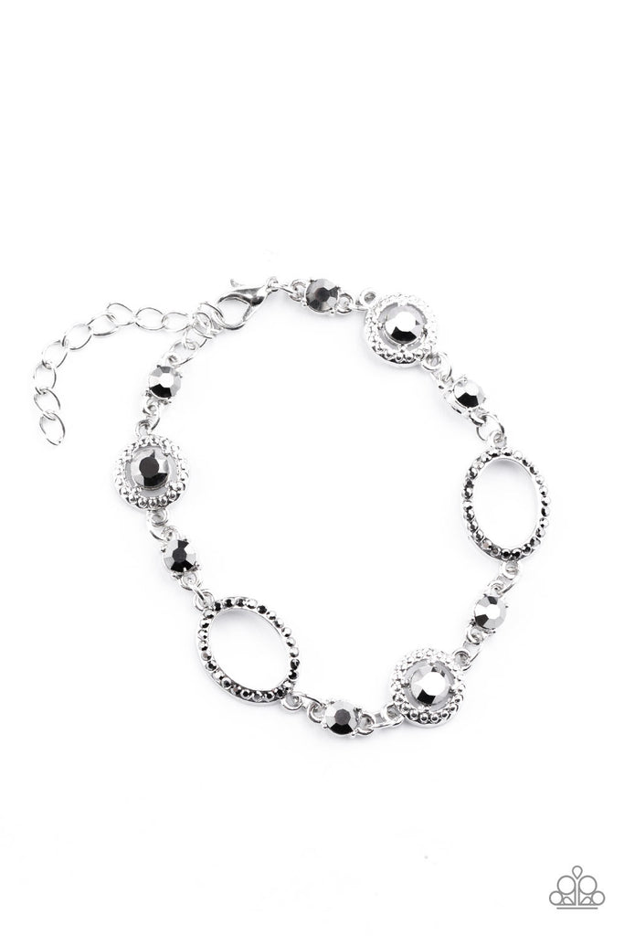 A mismatched collection of hematite rhinestone encrusted silver ovals and hematite rhinestone encrusted studded silver frames elegantly link around the wrist for a refined flair. Features an adjustable clasp closure.  Sold as one individual bracelet.   Get The Complete Look!  Necklace: "Pushing Your LUXE - Silver" (Sold Separately) 