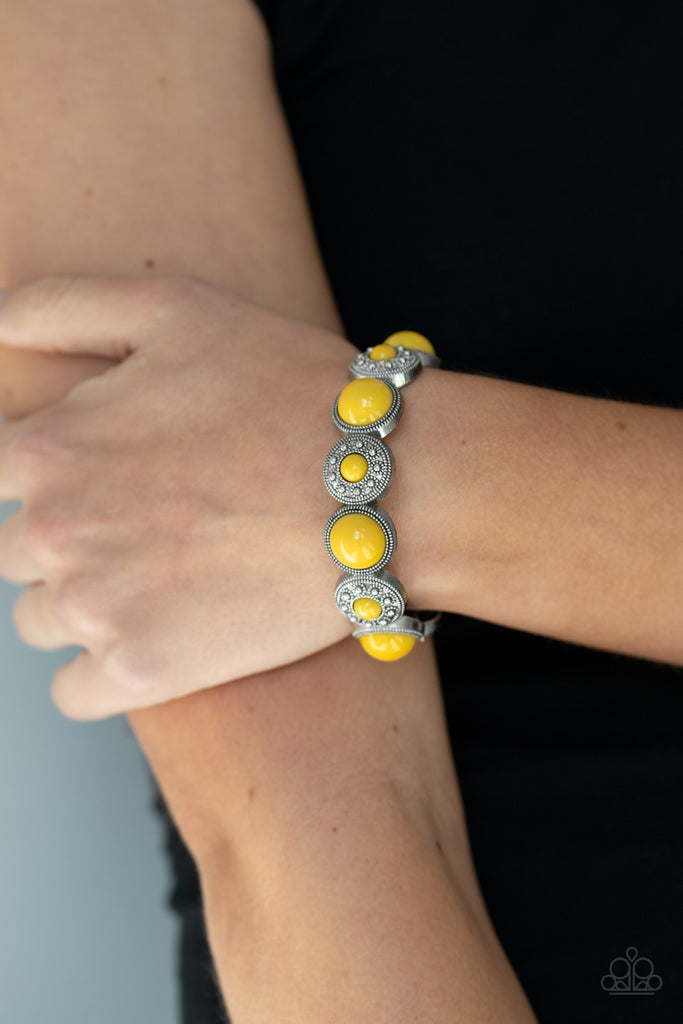 Dotted with sunny yellow beads, studded floral and metallic rope-like silver frames are threaded along a stretchy band around the wrist for a colorfully bubbly fashion.  Sold as one individual bracelet.