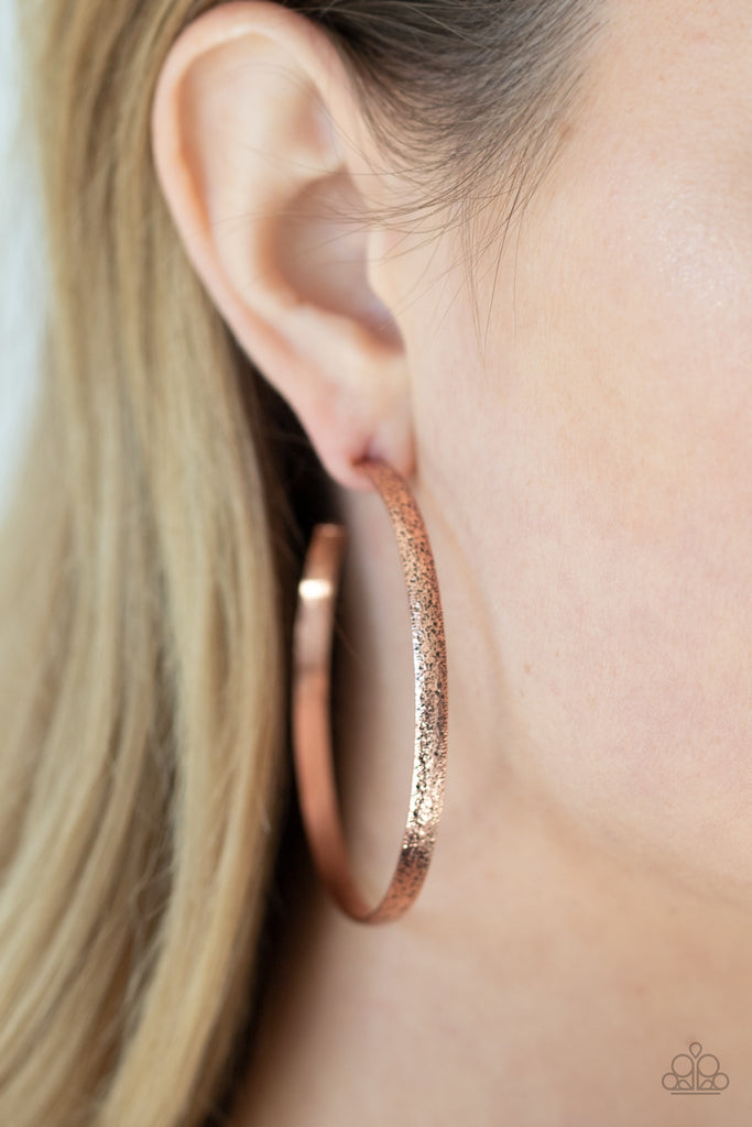 Delicately hammered in rustic shimmer, a shimmery copper bar curls around the ear, creating an oversized hoop. Earring attaches to a standard post fitting. Hoop measures approximately 2 1/4" in diameter.  Sold as one pair of hoop earrings.