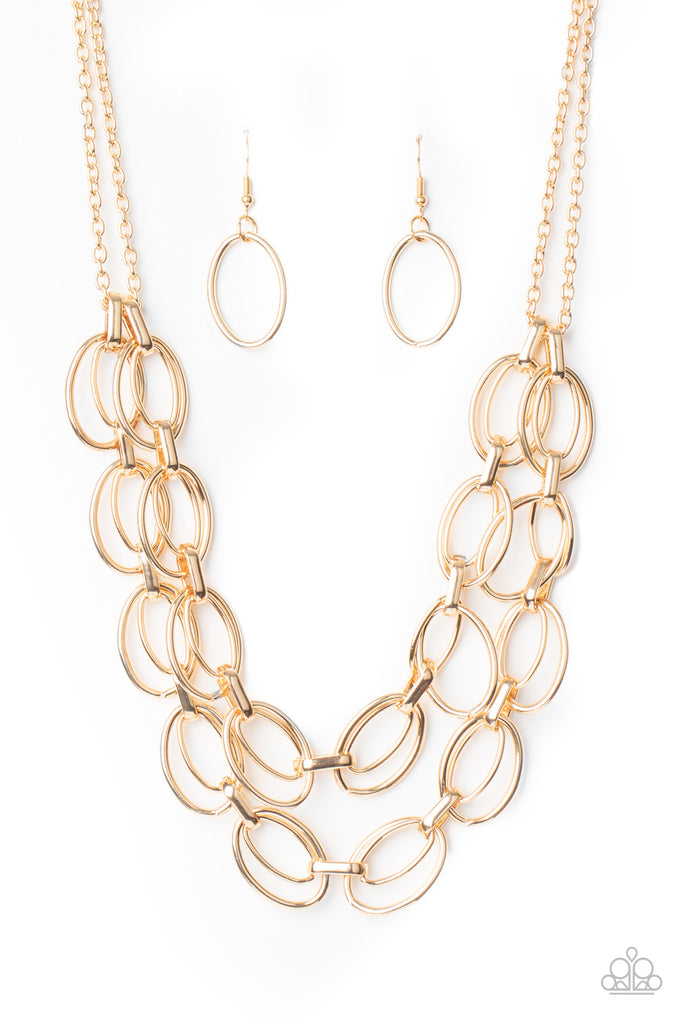 Varying in size, pairs of gold oval links connect into two bold layers below the collar for a gritty industrial look. Features an adjustable clasp closure.  Sold as one individual necklace. Includes one pair of matching earrings.  New Kit
