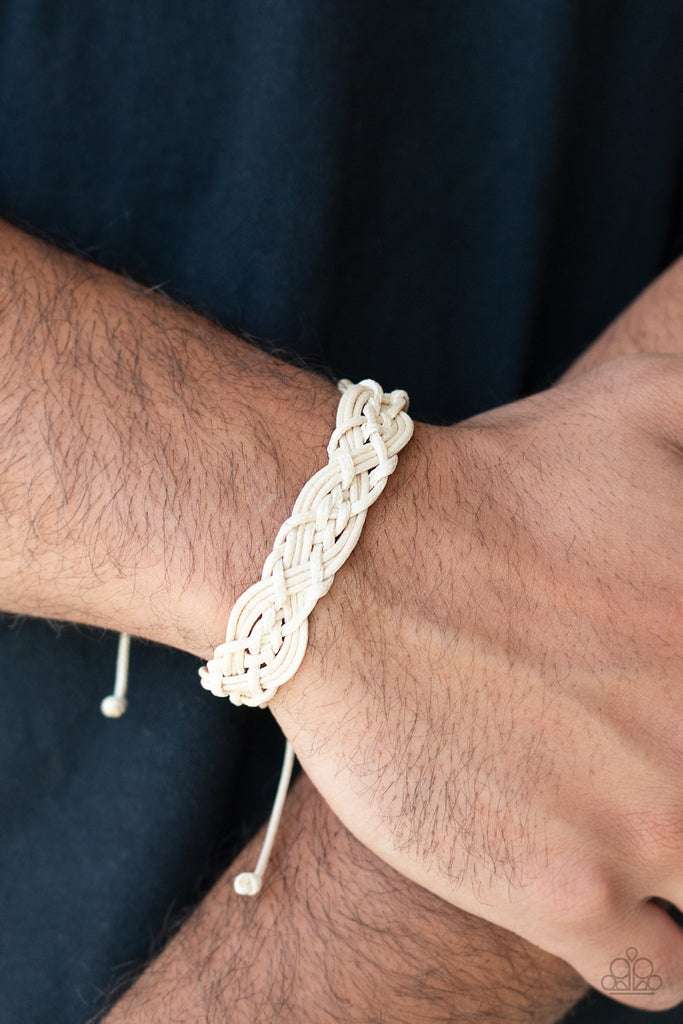 Strands of white twine-like cords ornately knot and braid around the wrist for a seasonal look. Features an adjustable sliding knot closure.  Sold as one individual bracelet.