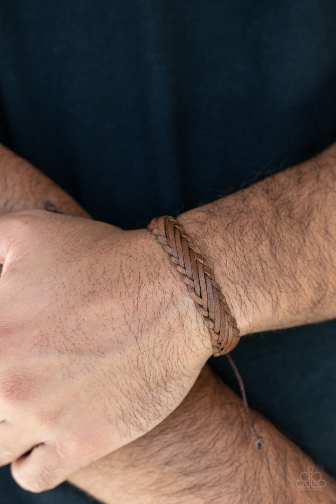 Rustic leather laces decoratively weave around the wrist, creating a rugged centerpiece. Features an adjustable sliding knot closure.  Sold as one individual bracelet.