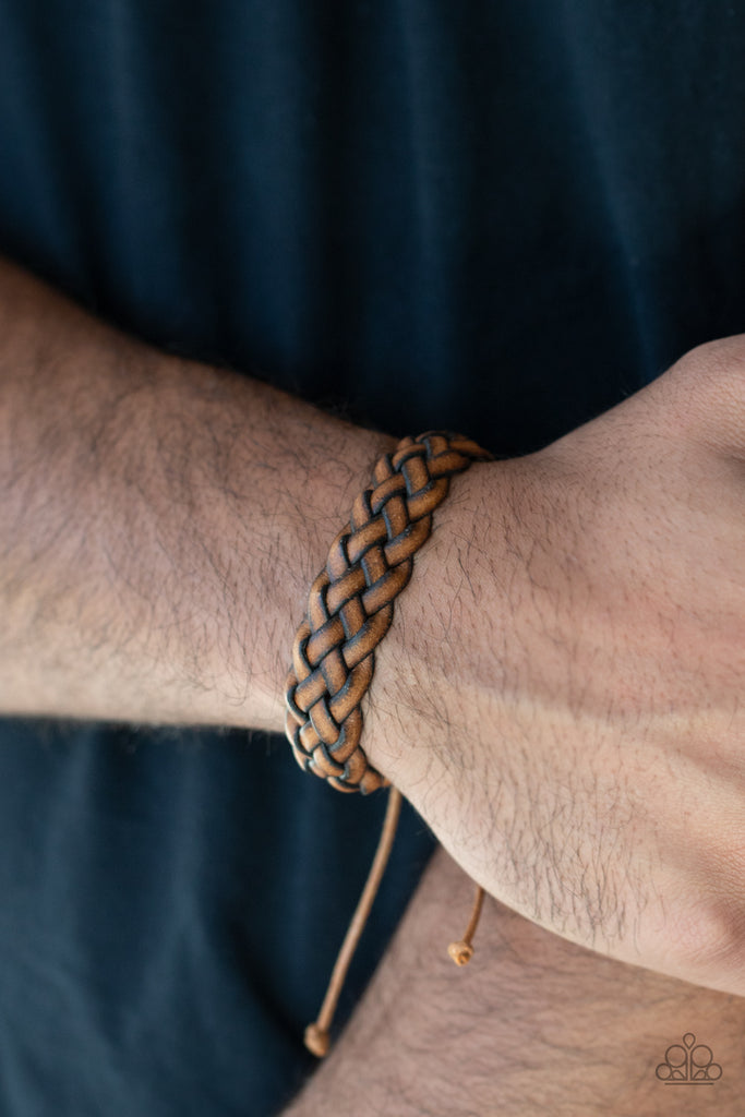 Rustic brown leather laces weave around the wrist, creating a rugged braid. Features an adjustable sliding knot closure.  Sold as one individual bracelet.