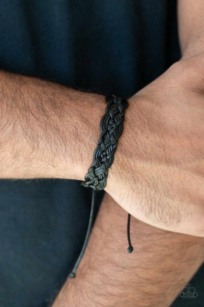 Strands of black twine-like cords ornately knot and braid around the wrist for a seasonal look. Features an adjustable sliding knot closure.  Sold as one individual bracelet.