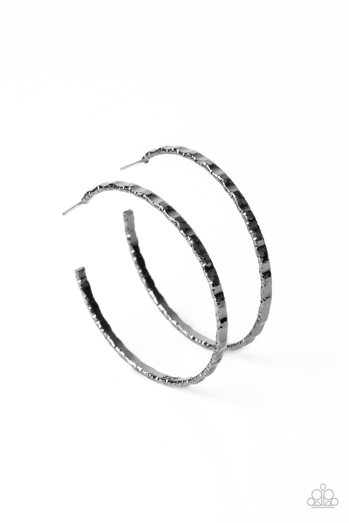 A gritty gunmetal hoop is hammered in grungy details for an edgy industrial flair. Earring attaches to a standard post fitting. Hoop measures approximately 2" in diameter.  Sold as one pair of hoop earrings.